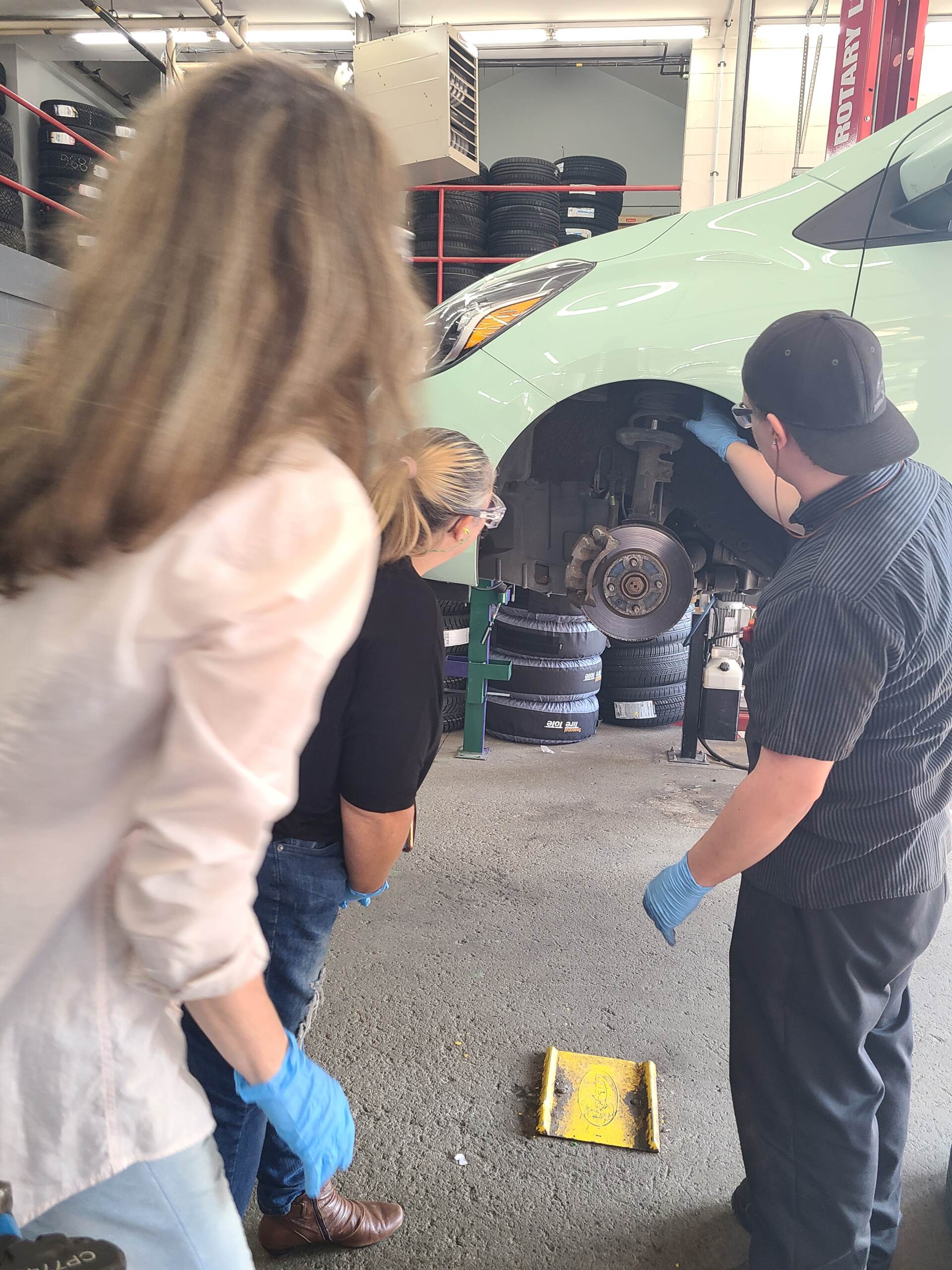 Two women working on a car